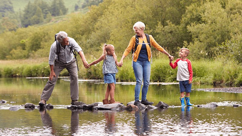 grandparents with children at the river