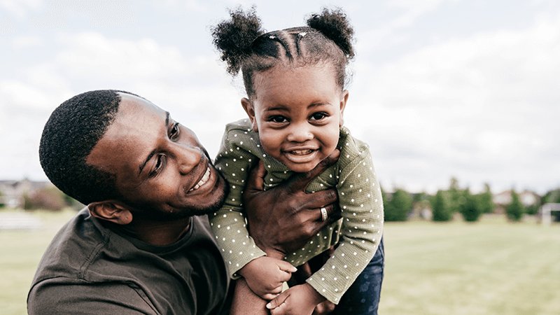 father holding daughter